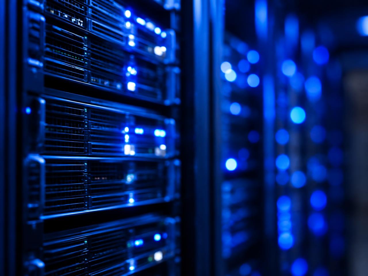 Rows of server racks with blue indicator lights